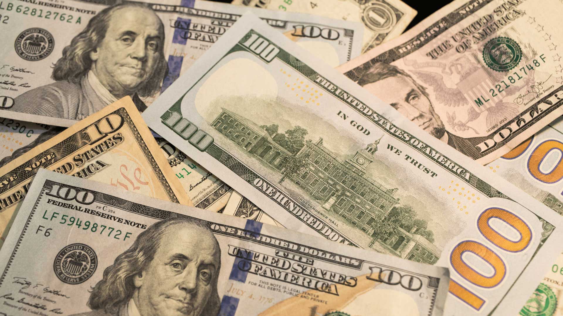 A close-up of scattered US hundred and fifty dollar bills